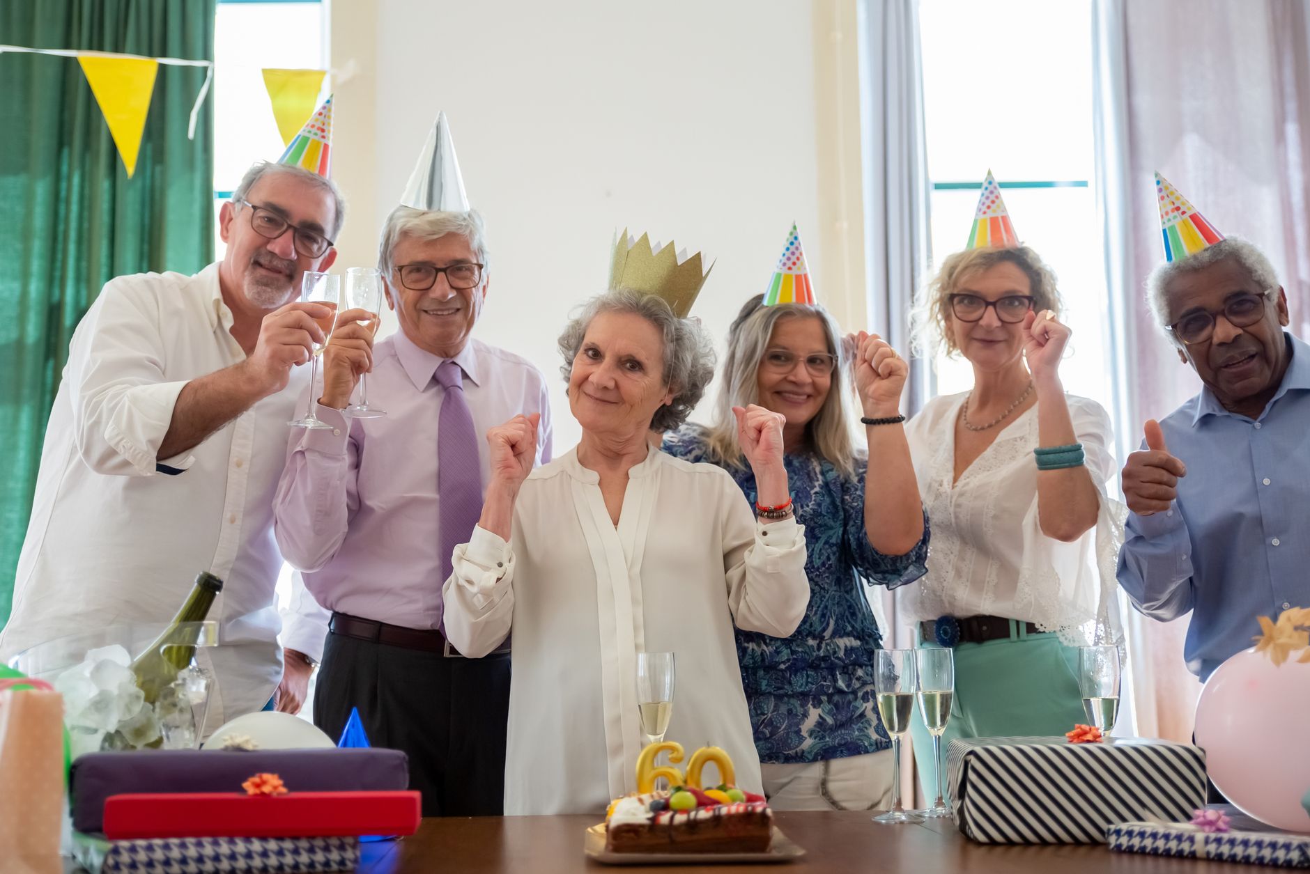 Senior person celebrating a milestone birthday surrounded by family