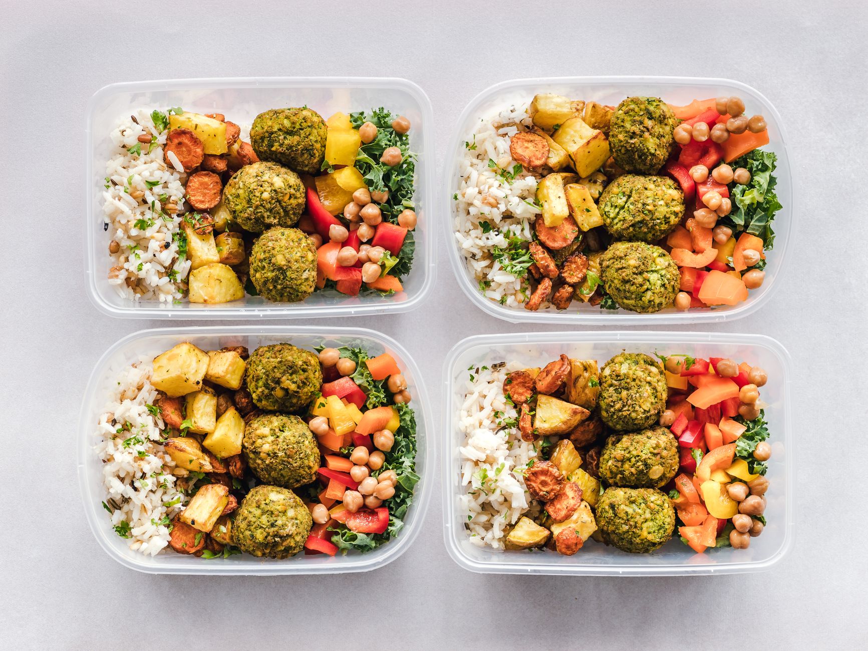 Meal prep containers with portioned food for calorie tracking