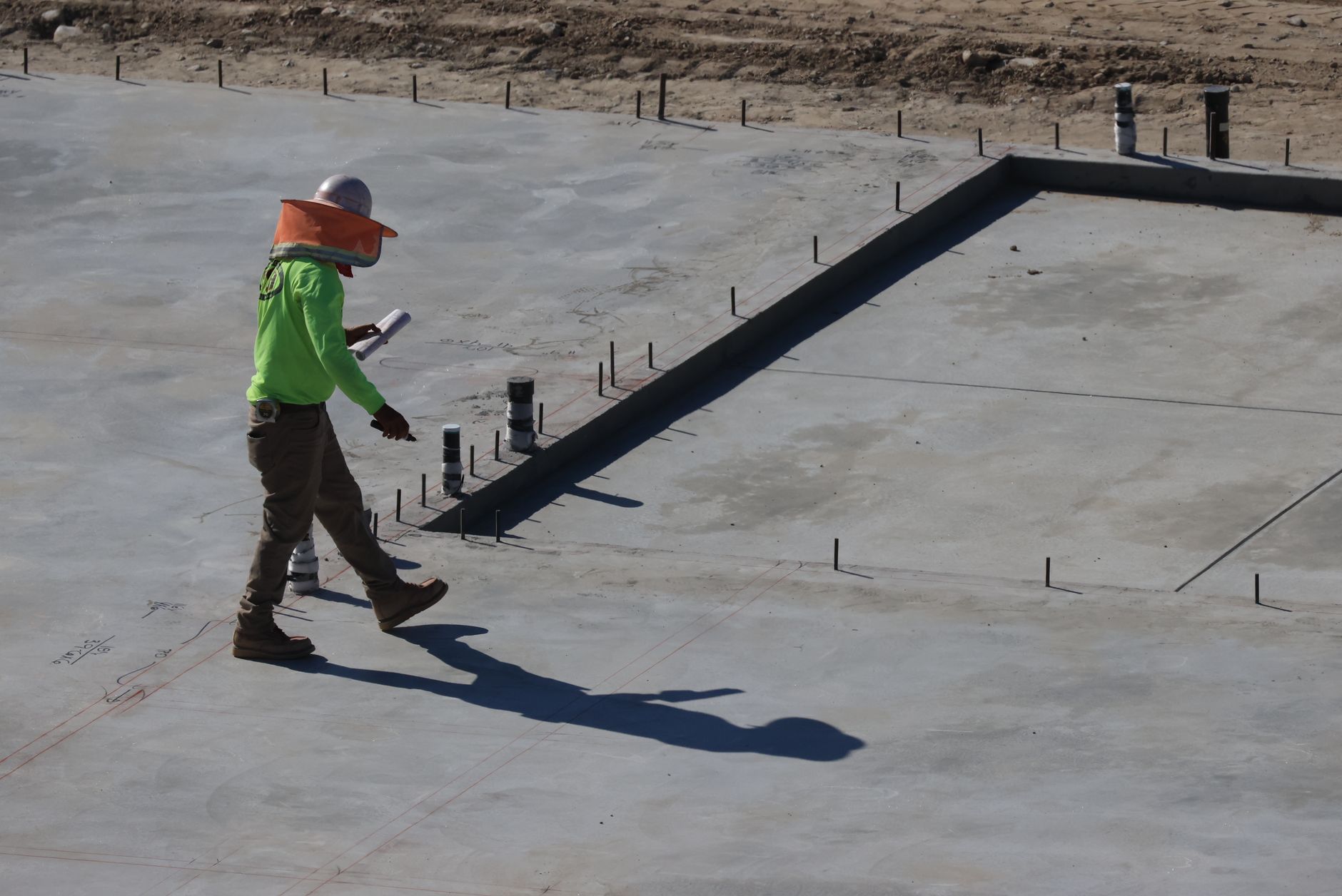 Construction worker finishing a concrete slab pour