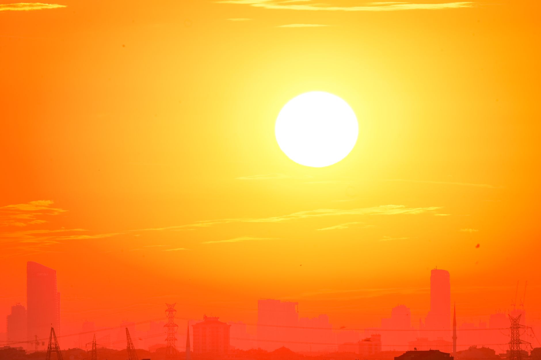 Hot summer sun and thermometer showing extreme heat wave temperature