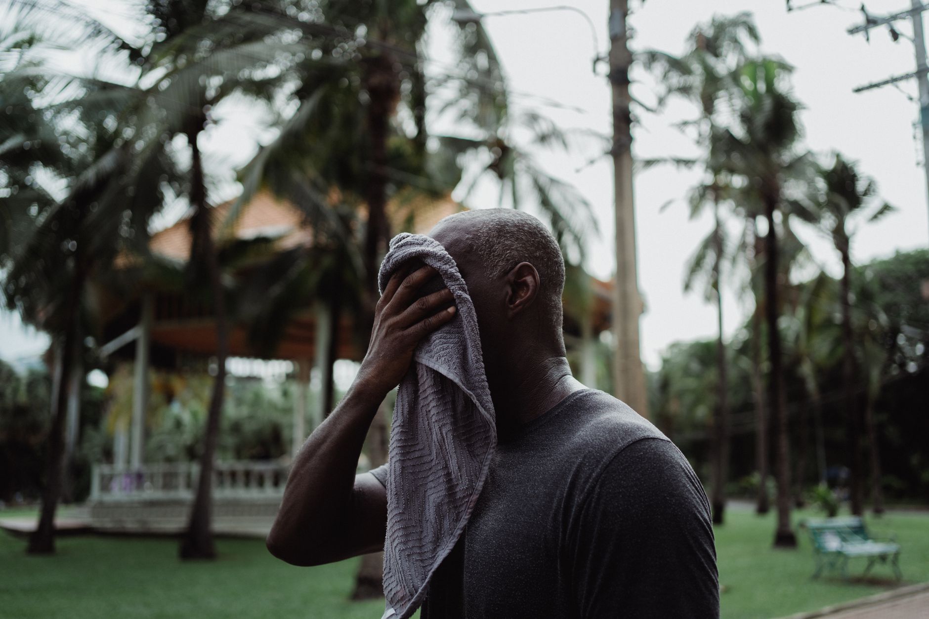 Person outdoors sweating in humid summer heat — heat index and body cooling