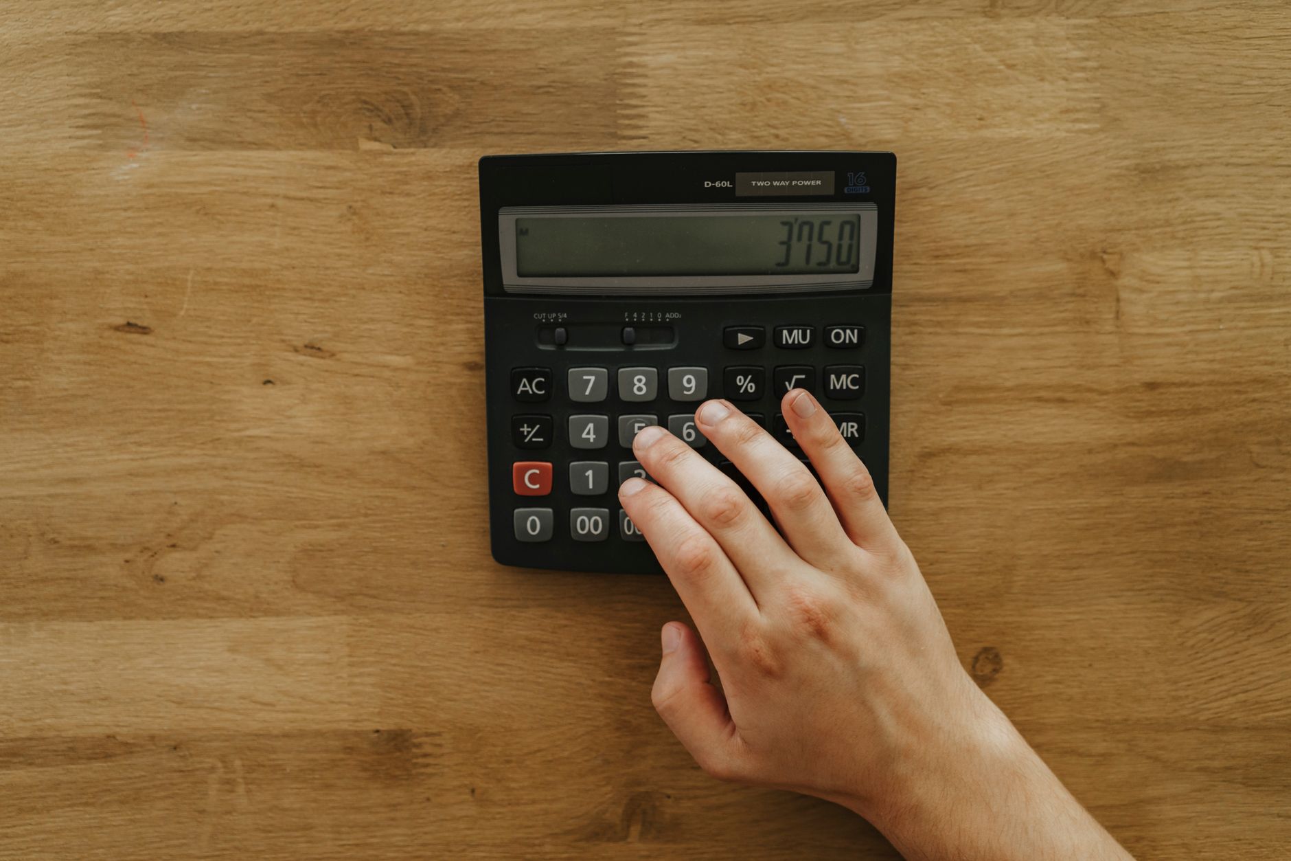 Person using a calculator for everyday tasks