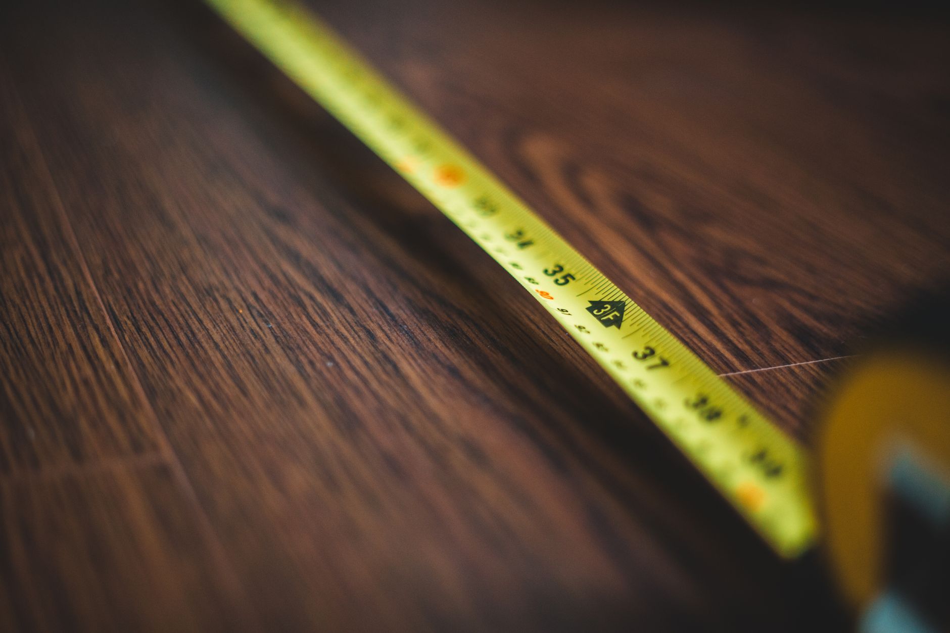 Tape measure on a wood floor during a room renovation