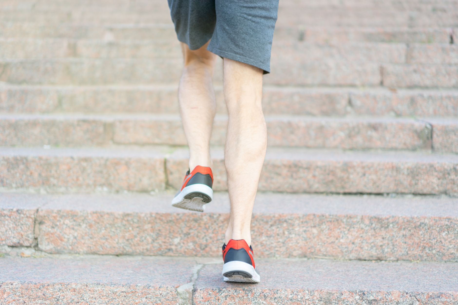Person walking outdoors tracking steps with pedometer