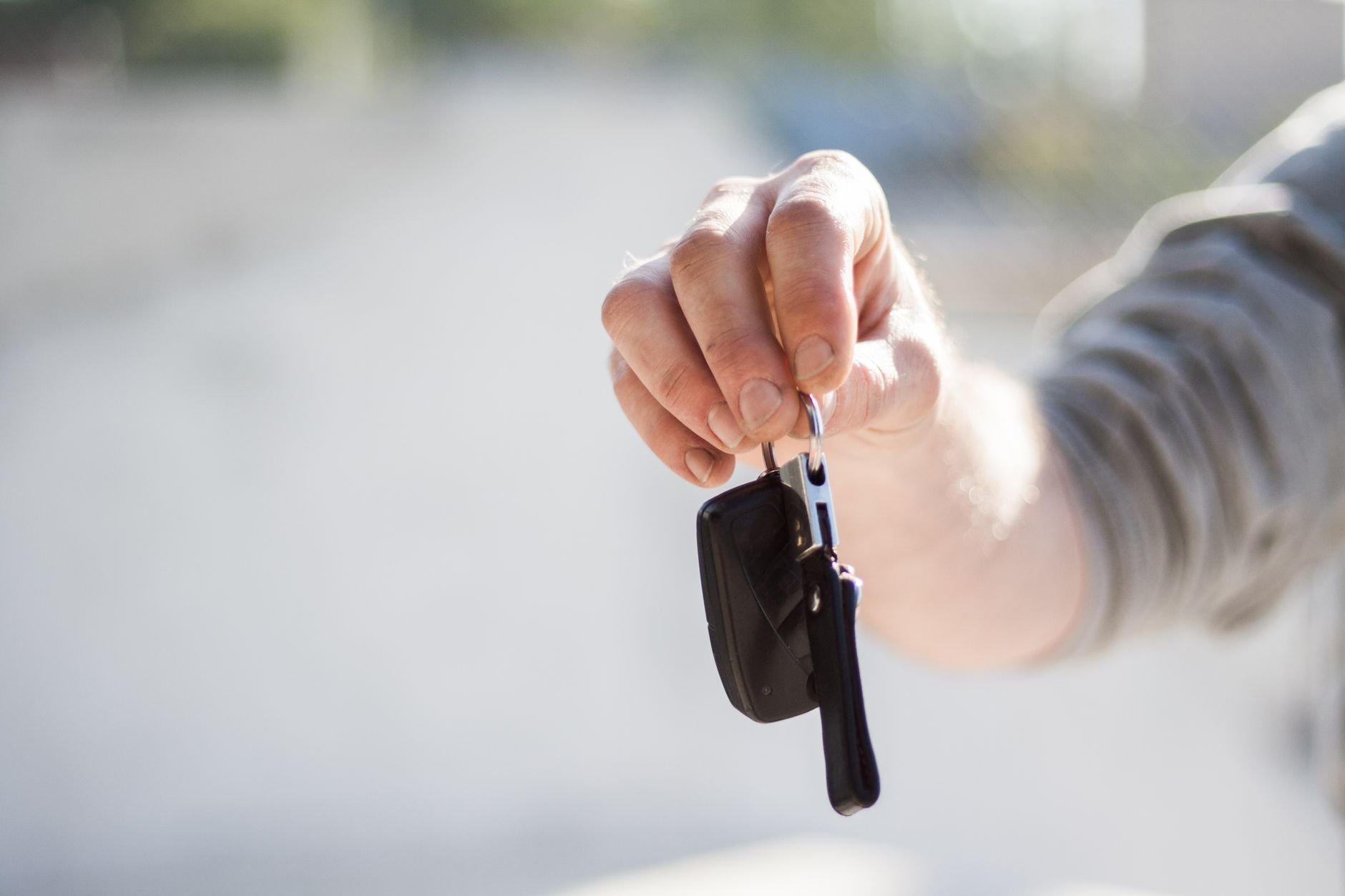 Car dealer handing over keys for a new leased vehicle