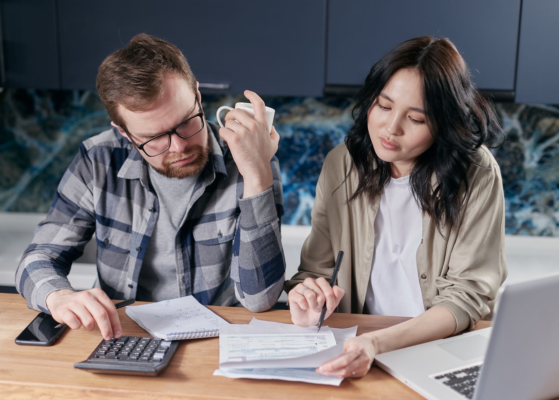 Couple reviewing their debt payoff plan and finances at home