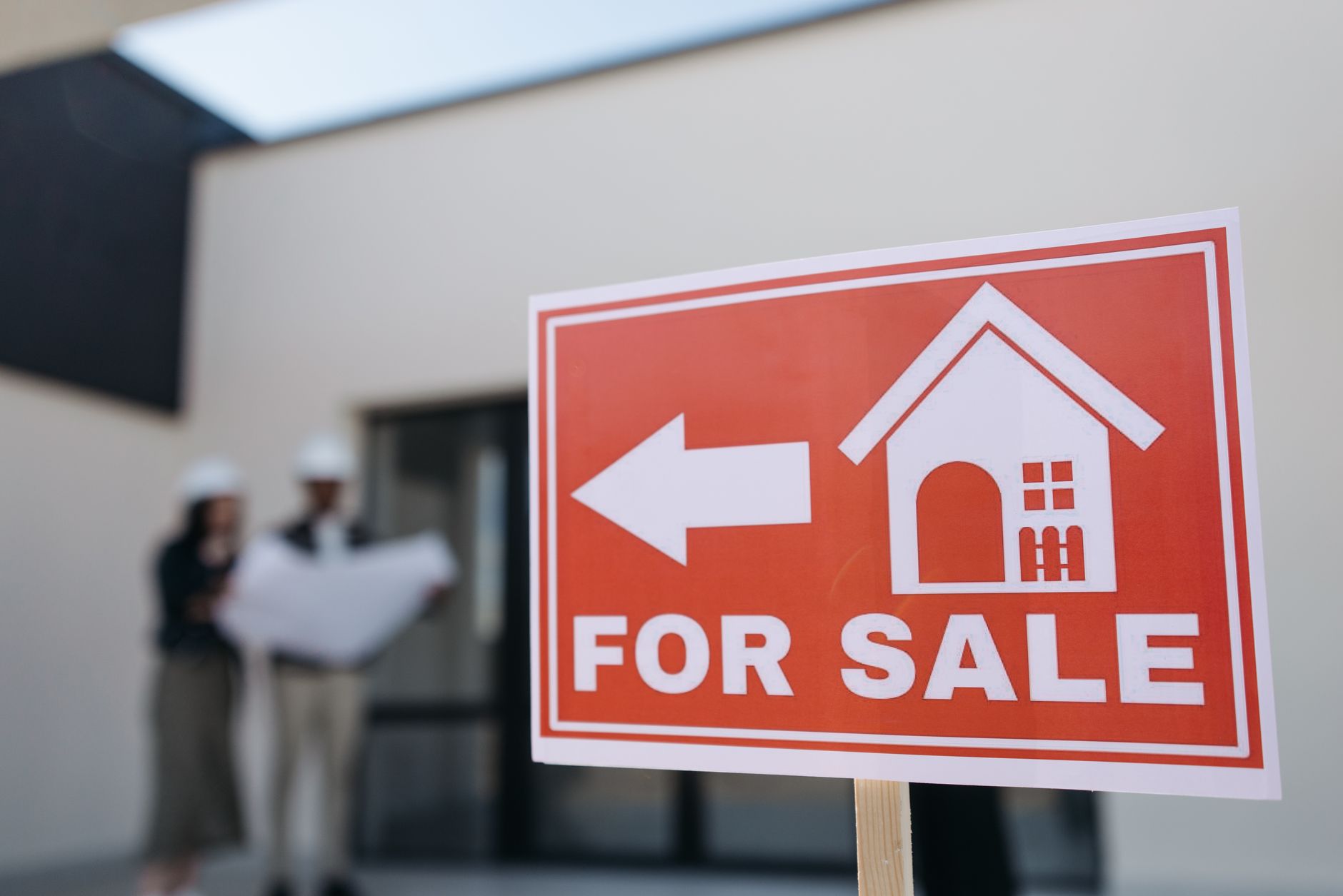 For sale sign in front of a house during a home purchase decision