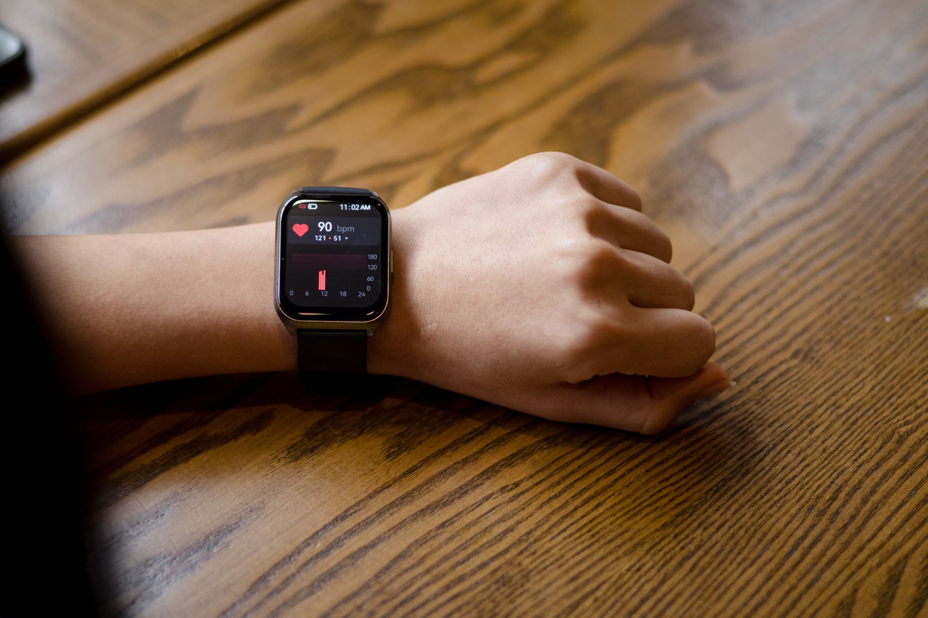 Person checking heart rate on smartwatch during exercise