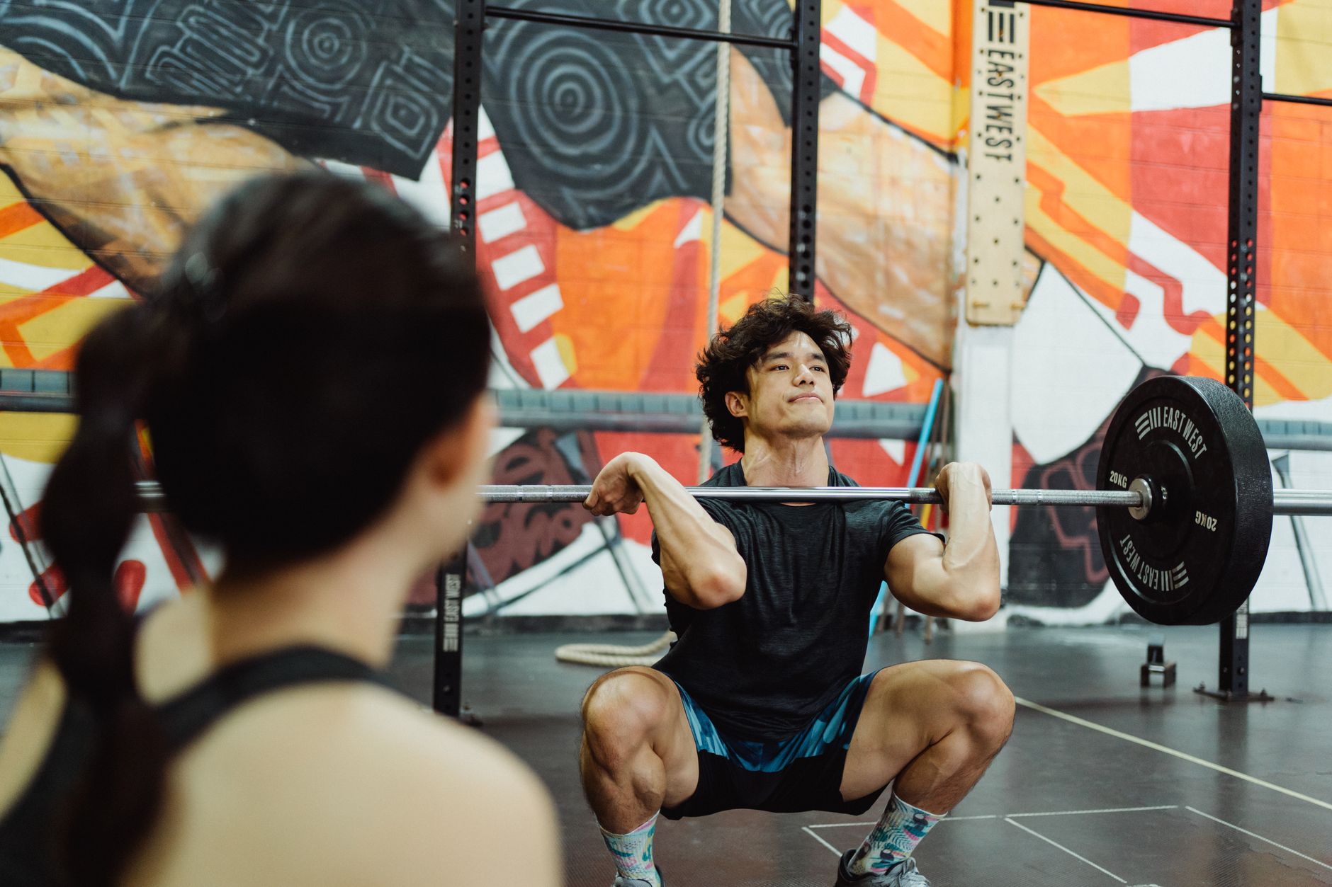 Weightlifter performing a barbell back squat to estimate one rep max