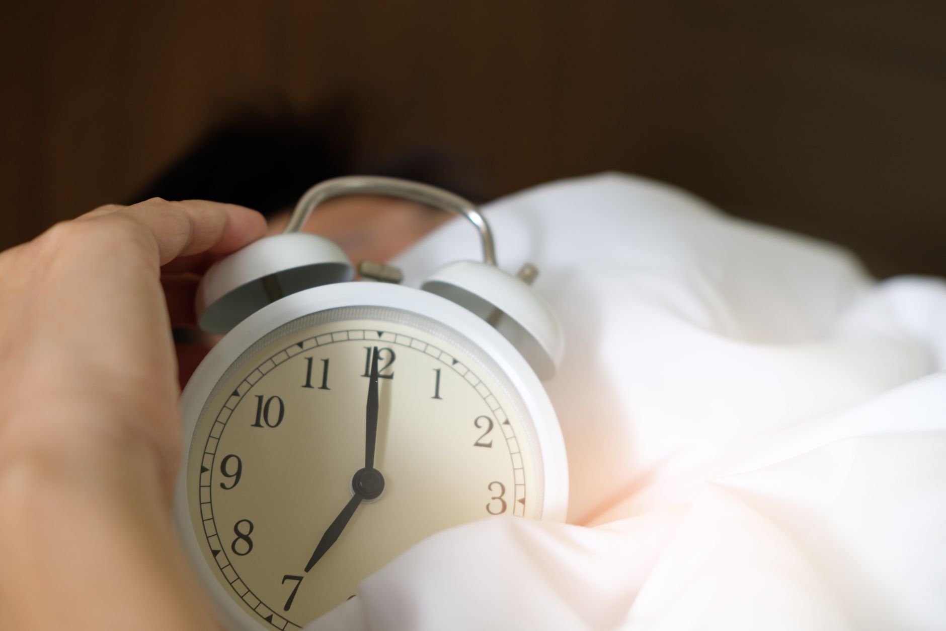 Alarm clock on nightstand — sleep schedule and wake time
