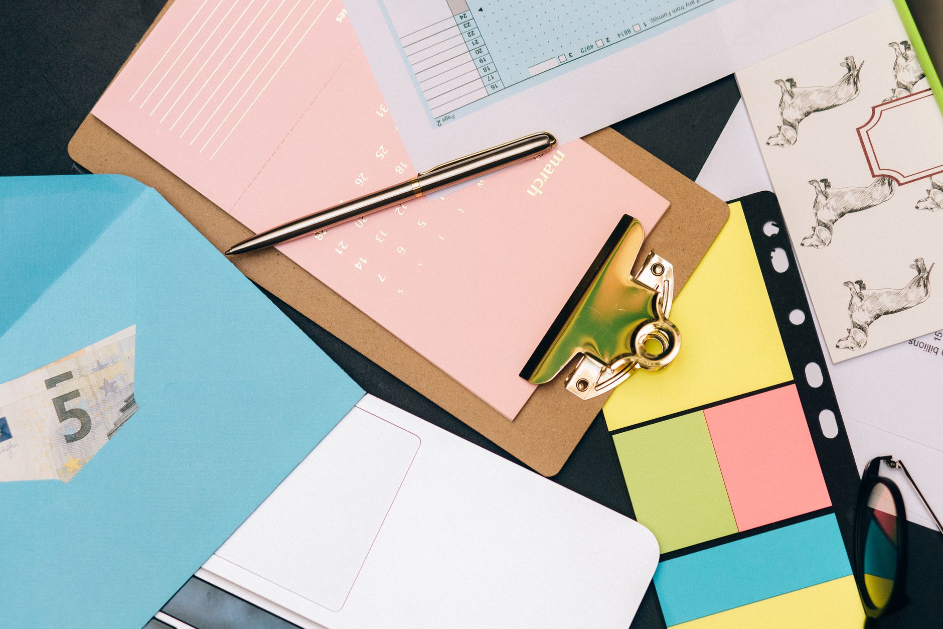 Counting days on a calendar with a pen at an office desk