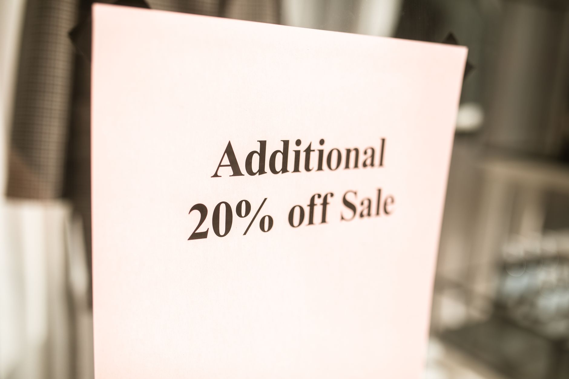 Retail store aisle with sale signs and discounted prices