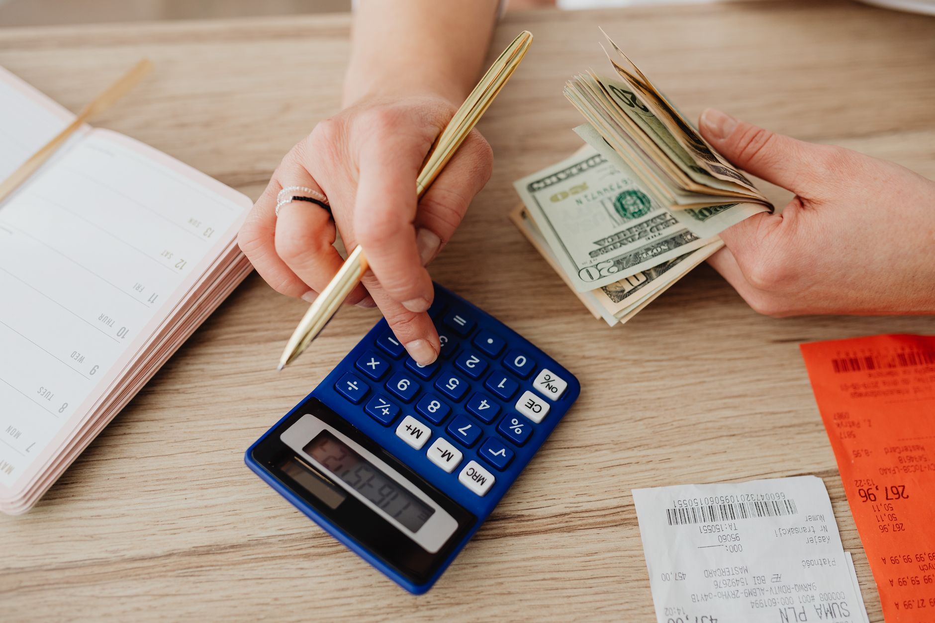 Reviewing mortgage budget and monthly payment breakdown on paper