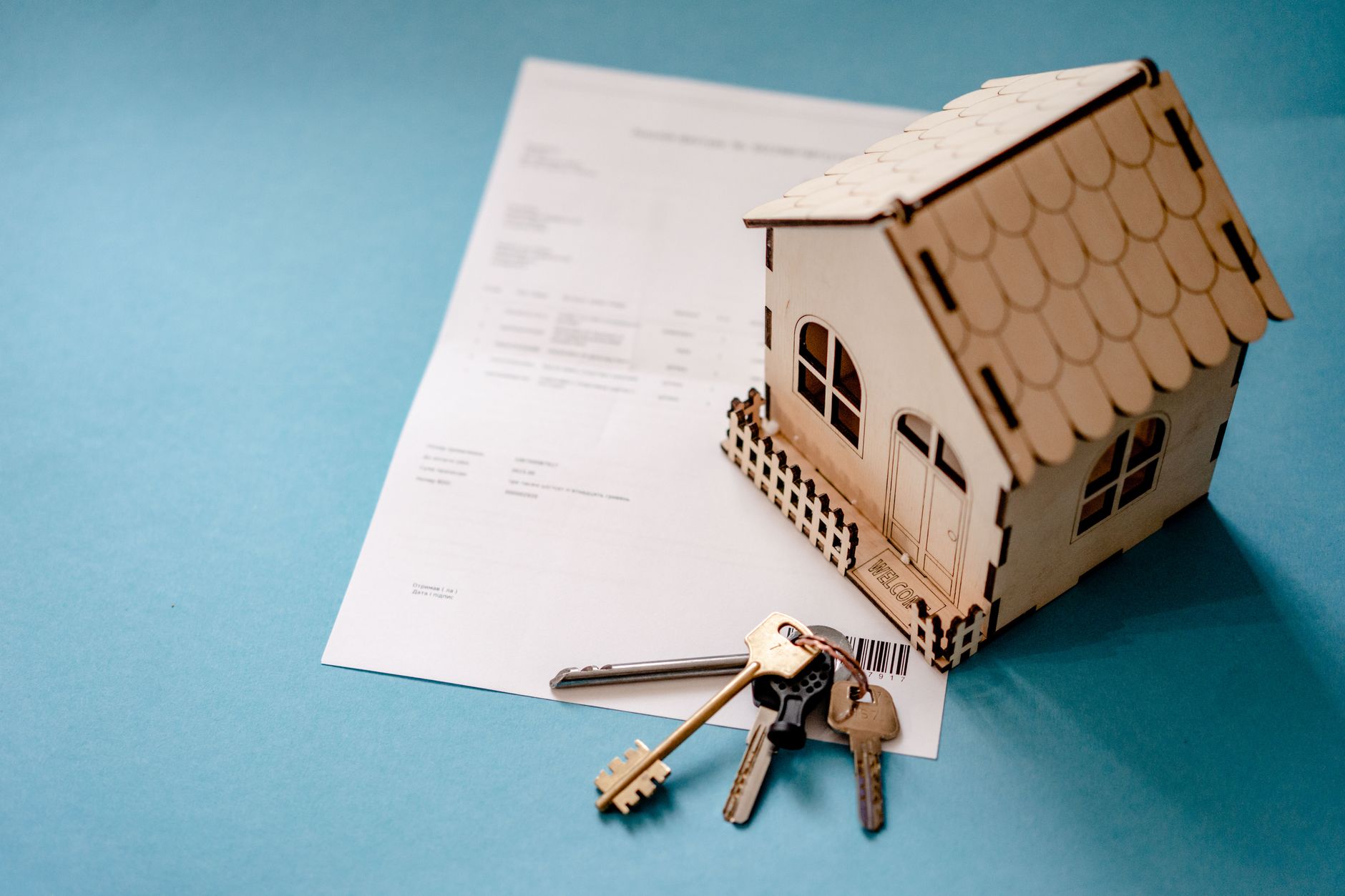 Couple signing mortgage paperwork with a lender to buy a home