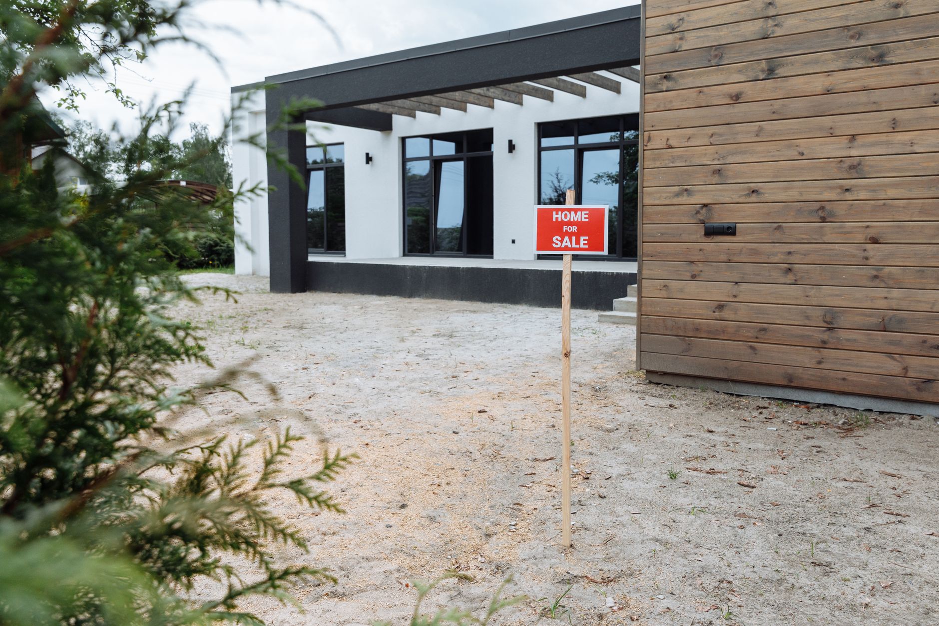 Exterior of a house for sale with a real estate sign