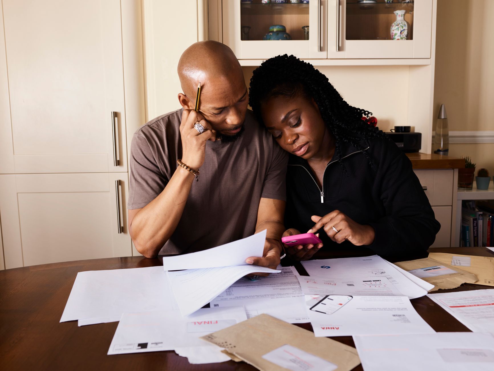 Family reviewing their home budget and mortgage costs at the kitchen table