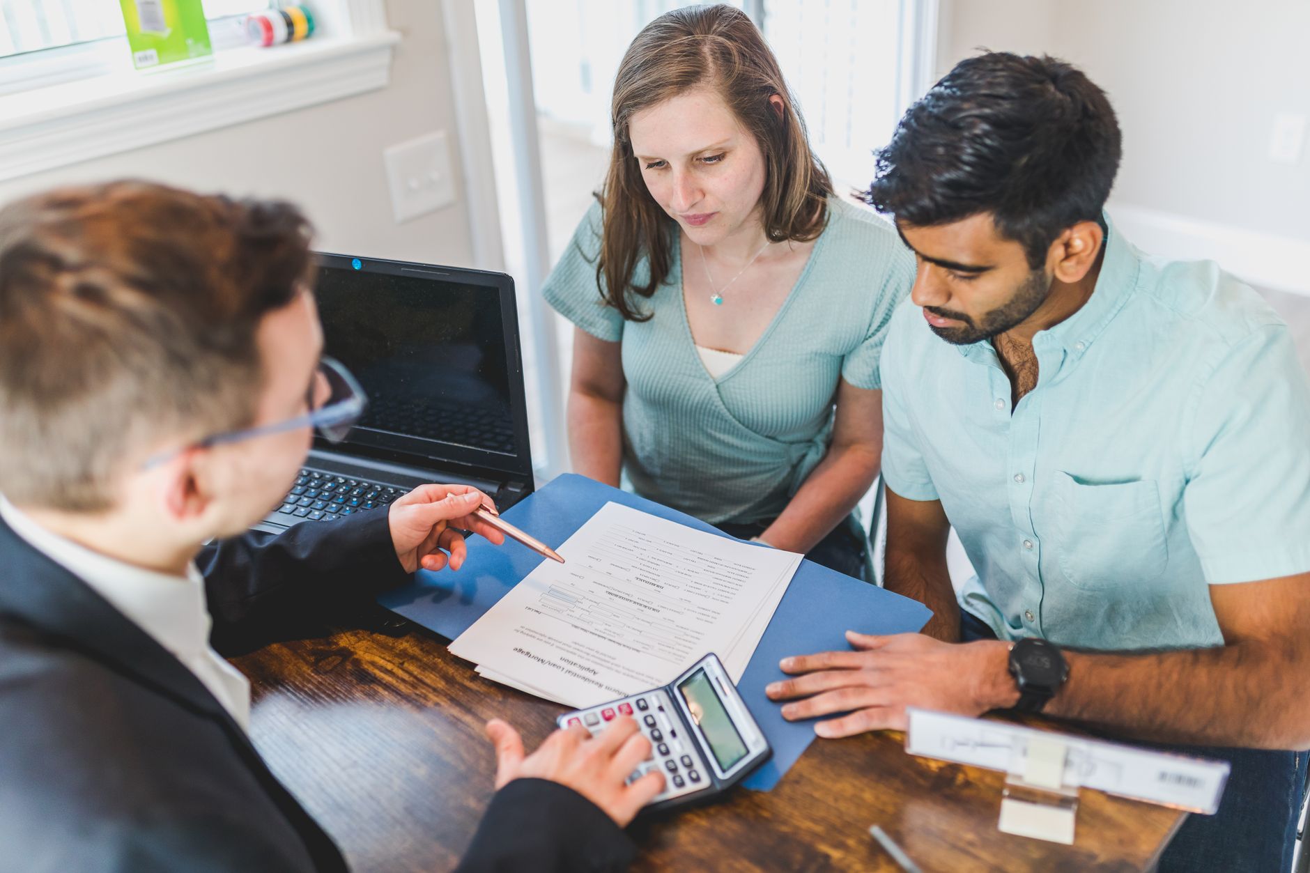 Couple reviewing mortgage refinance documents at home