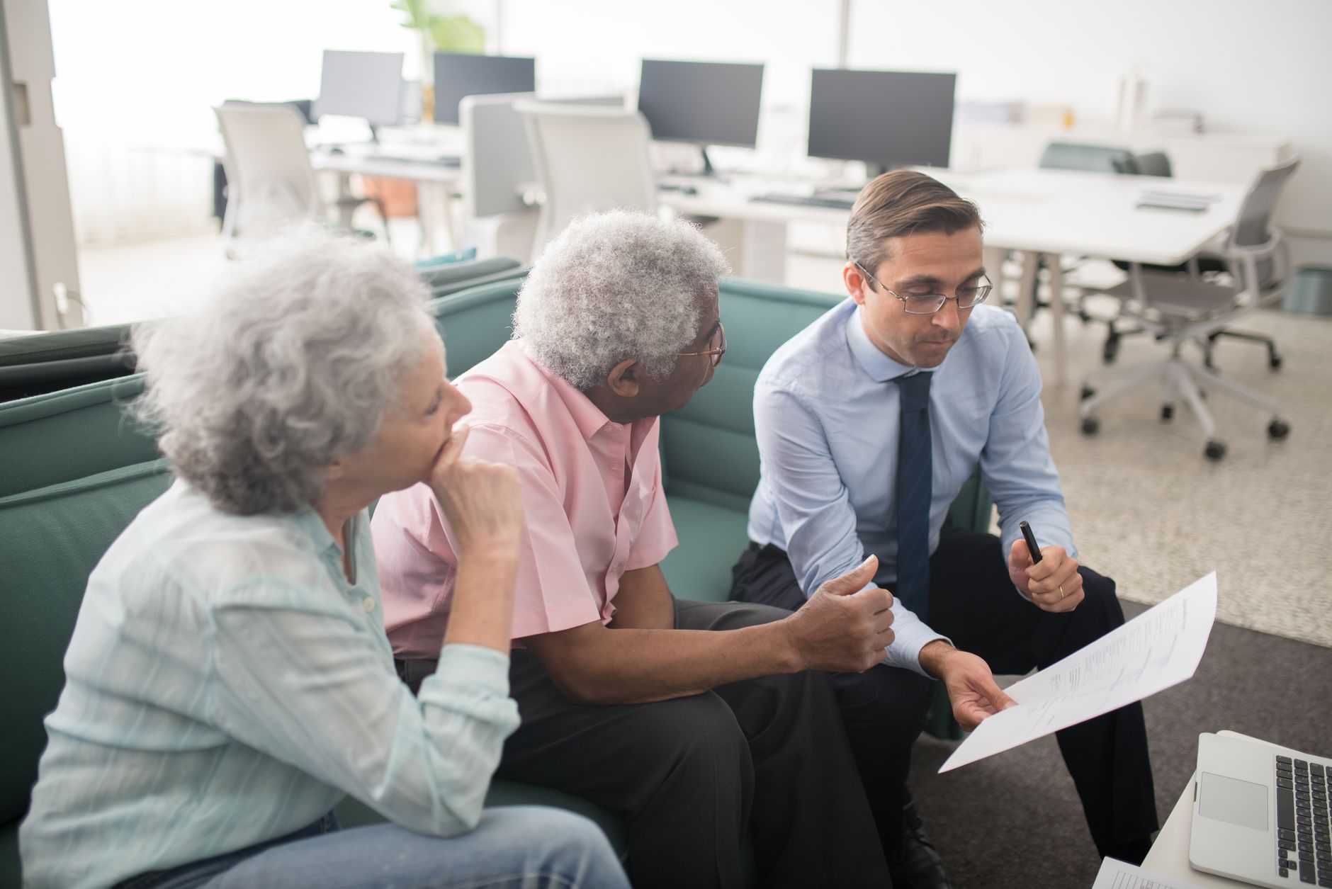 Financial advisor meeting with couple to plan retirement strategy