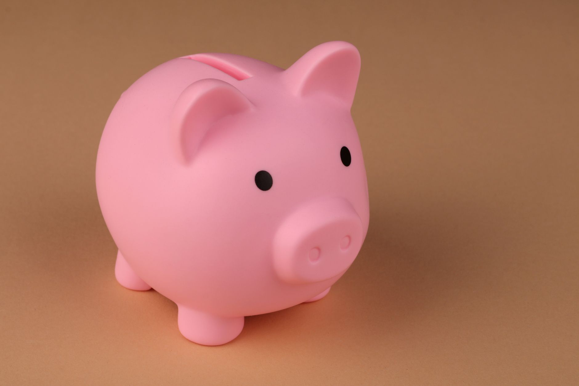 Piggy bank and coins representing savings money goals