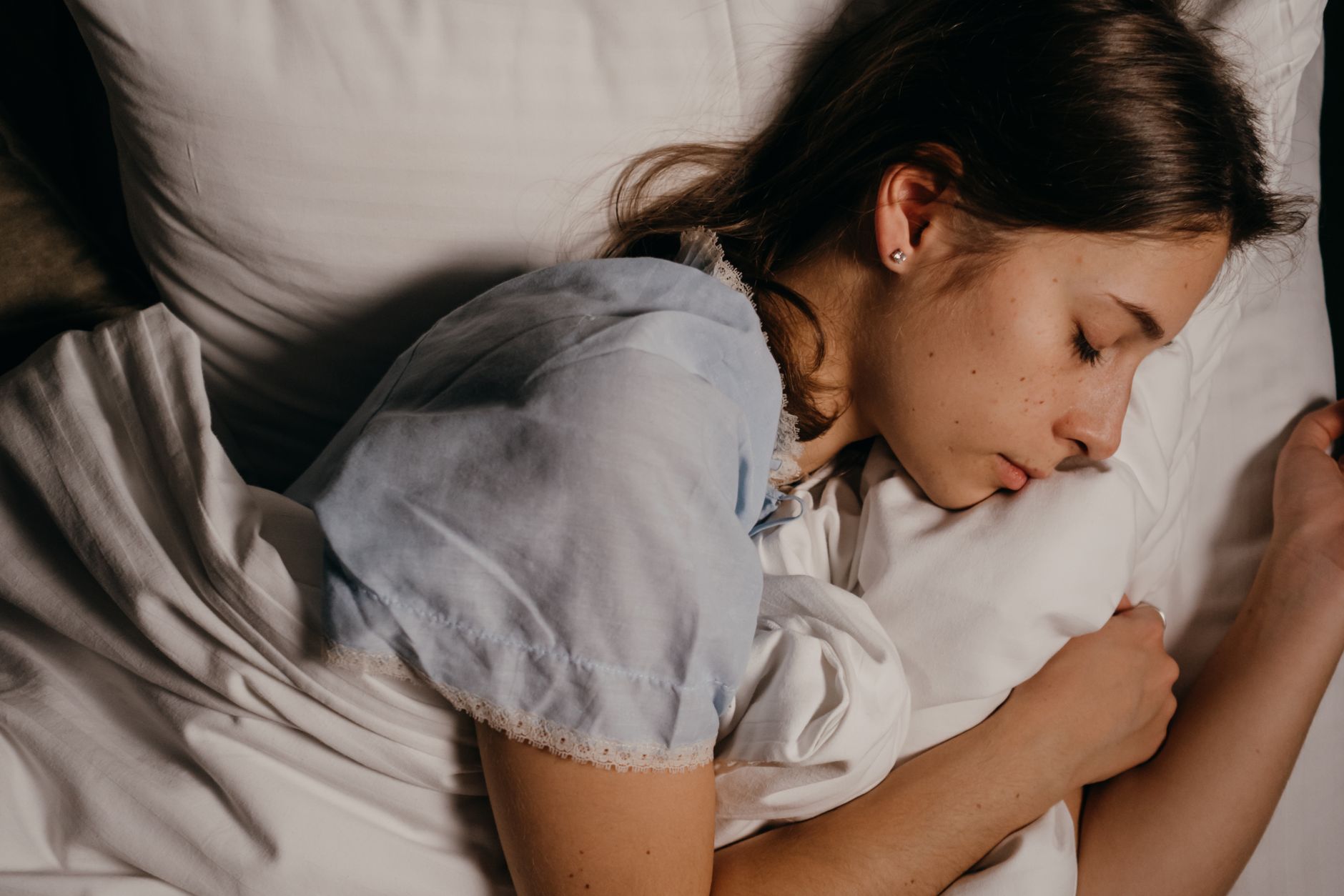 Person sleeping soundly in bed at night