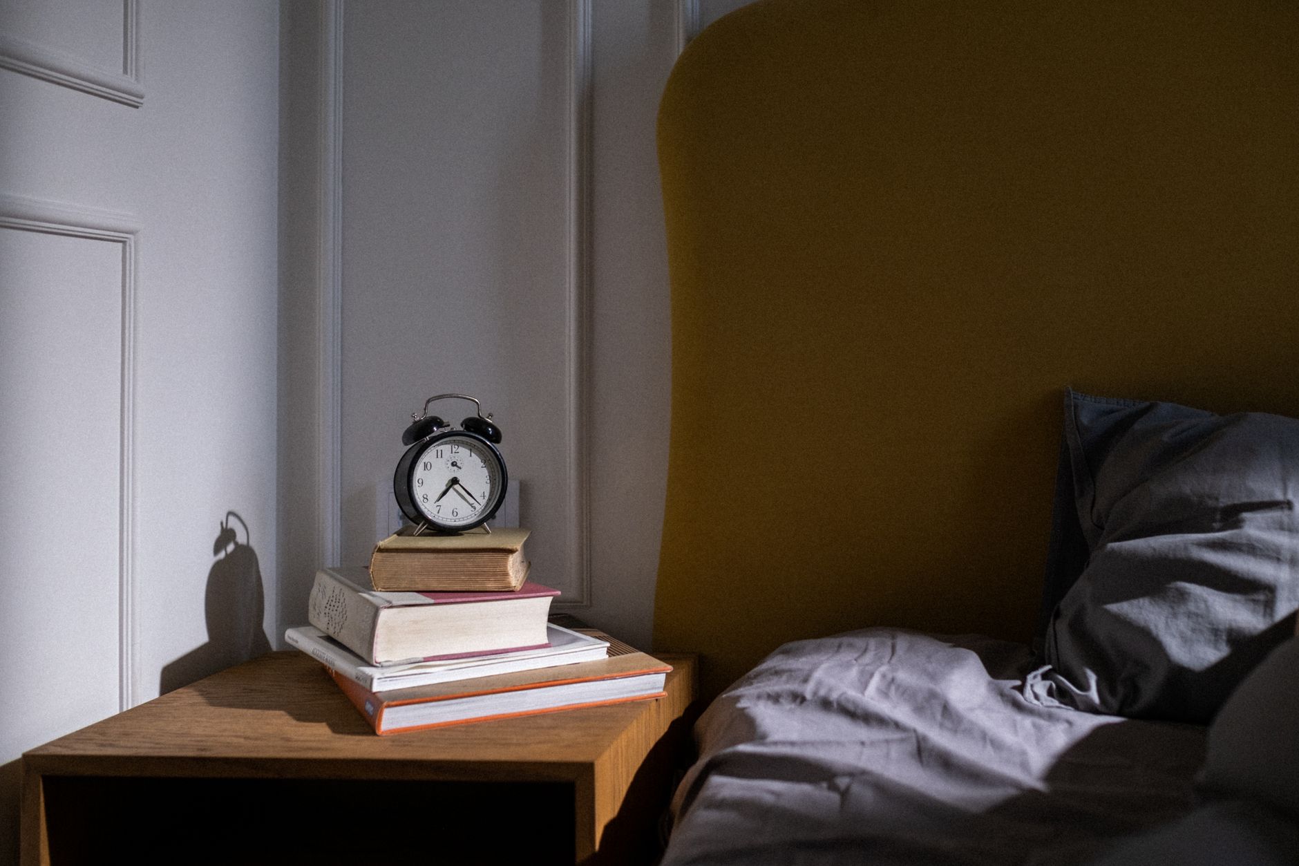 Alarm clock on bedside table with morning light