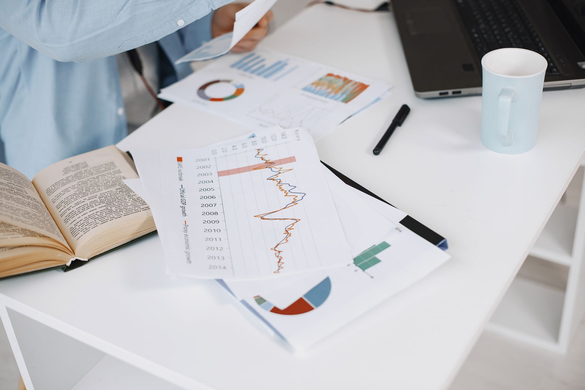 Data analysis charts and numbers on an office desk