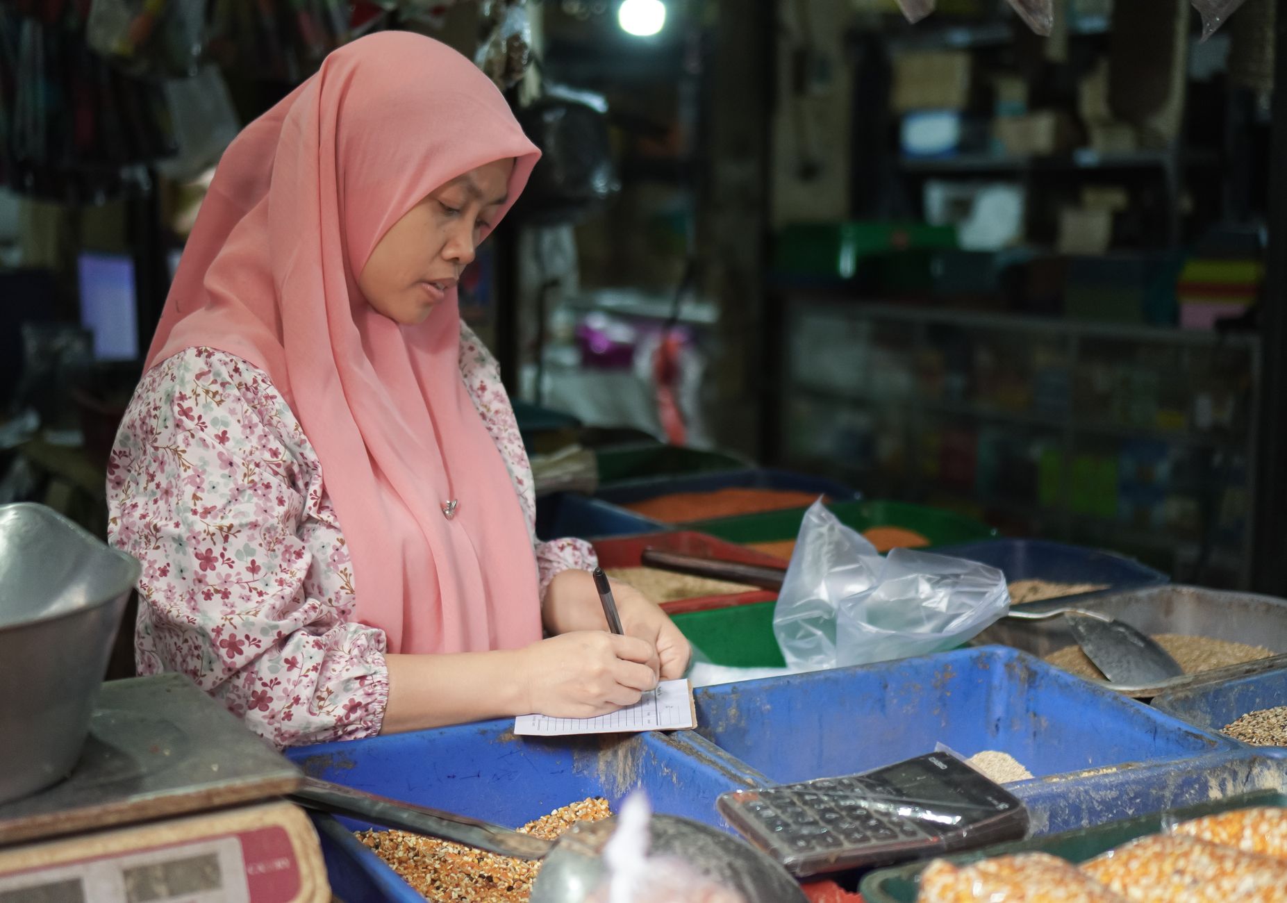 Calculator and shopping bags representing retail pricing calculations