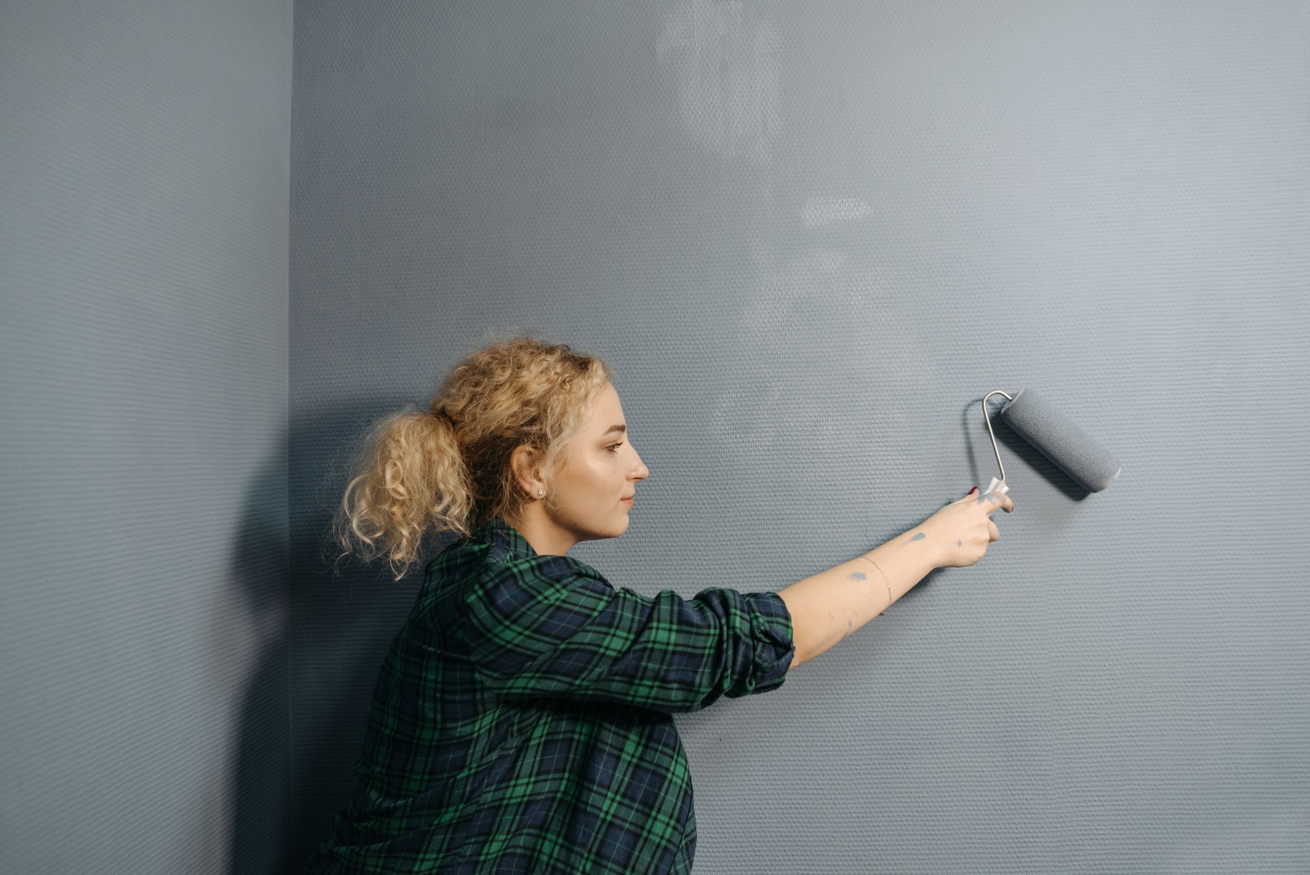 Painter painting interior wall white